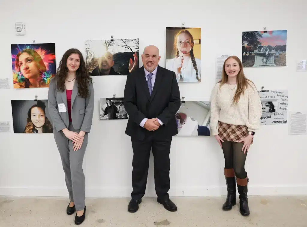 myFace Through My Lens Winners: Sophia Smilenov, Johnathan Hornig, and Eilie Bell standing in front of honored entries.